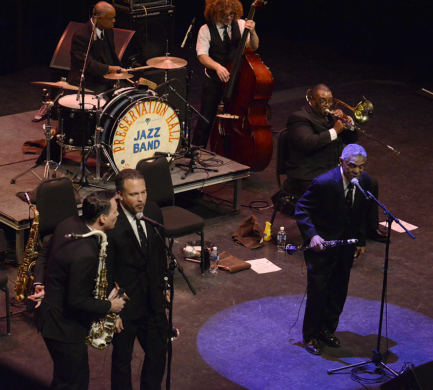 a group of men standing next to each other on top of a stage