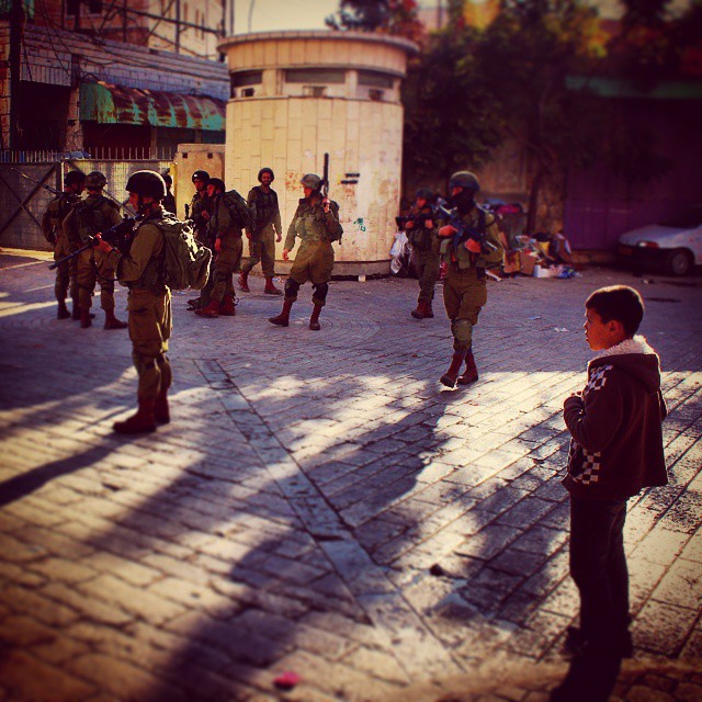 a group of young soldiers standing on the street