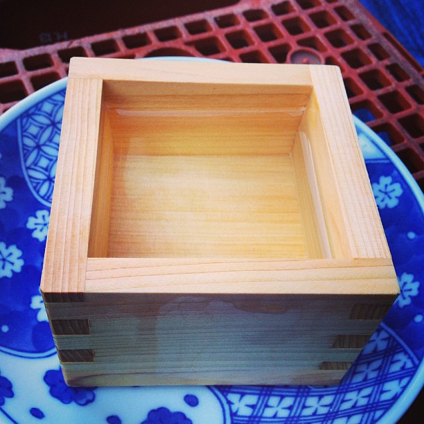 small empty wooden box sits on a plate