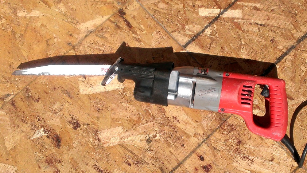 a cordless nail gun lying on the ground