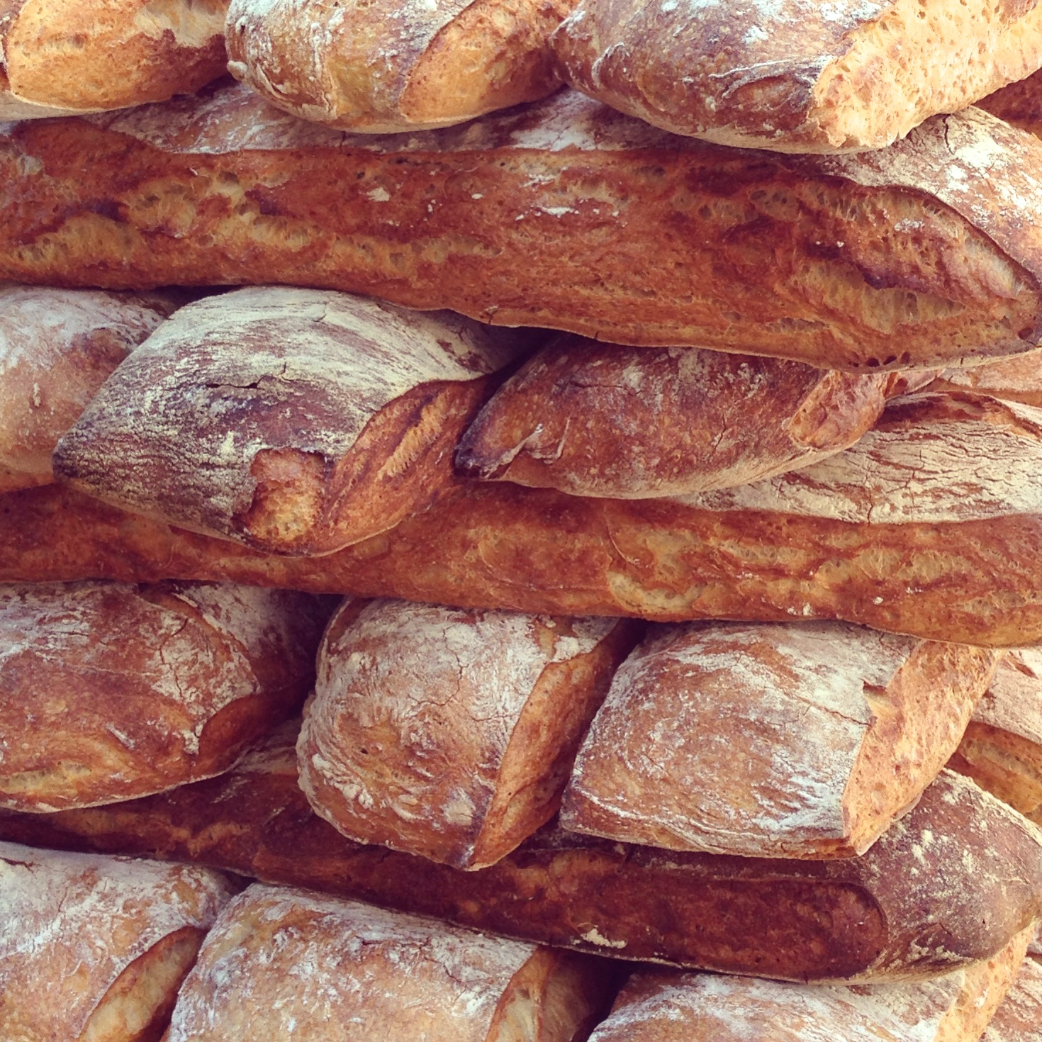 a pile of different kinds of bread on display