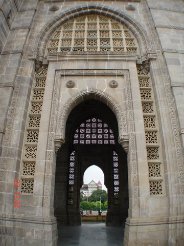 an open arch with a walkway leading into the inside