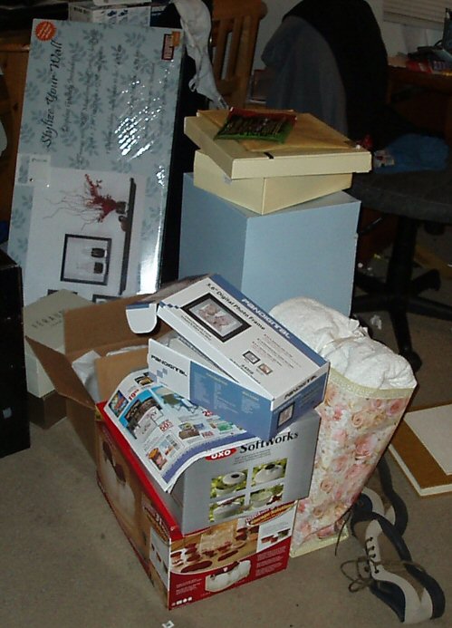 several boxes are piled on the floor in front of a computer desk