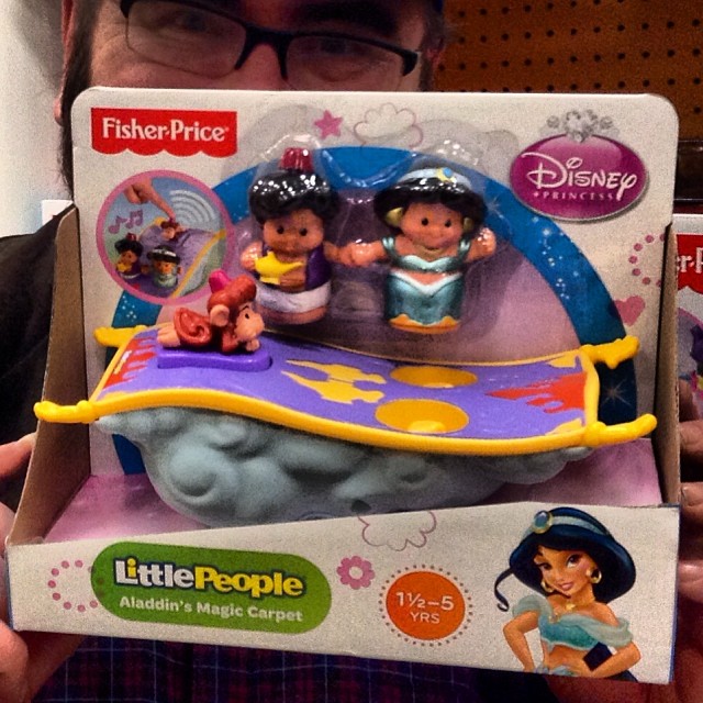 a box of little people has two children sitting on it
