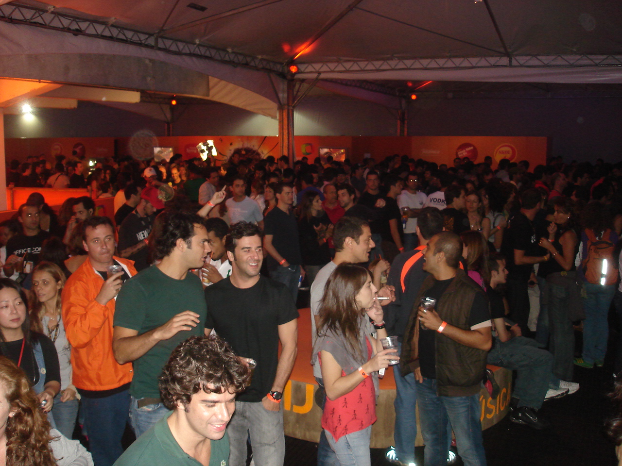 several people standing together in a room with large amount of fans