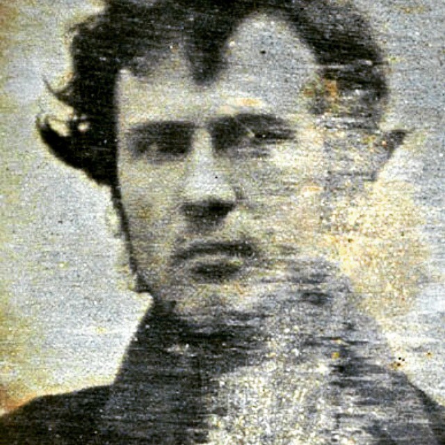 a sepia pograph of a man with long hair