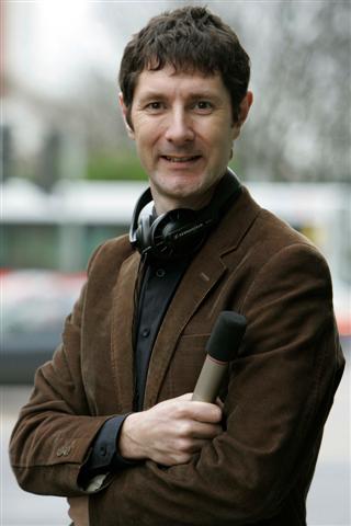 a man wearing headphones holding a microphone