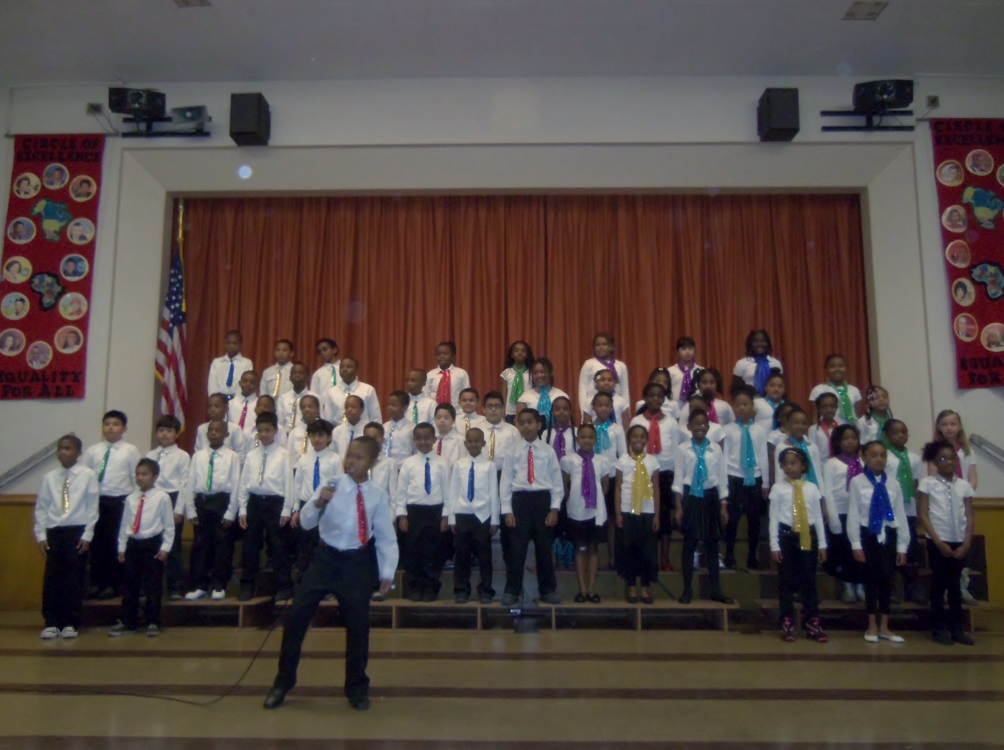 a choir and a man singing in front of an audience