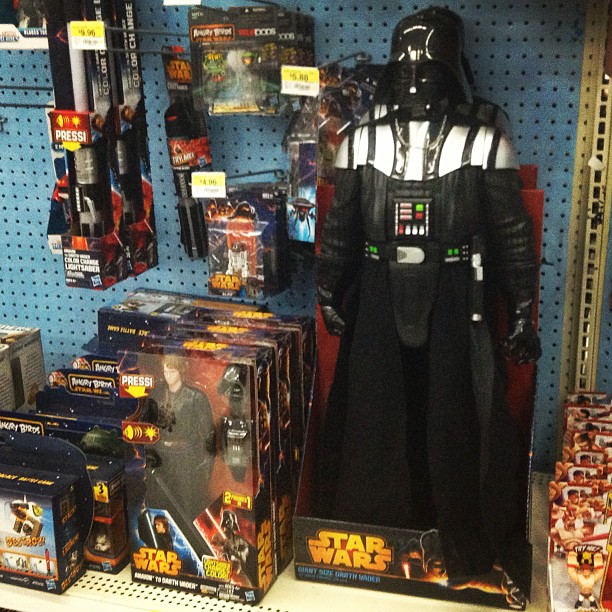 star wars action figures and merchandise displayed on a wall