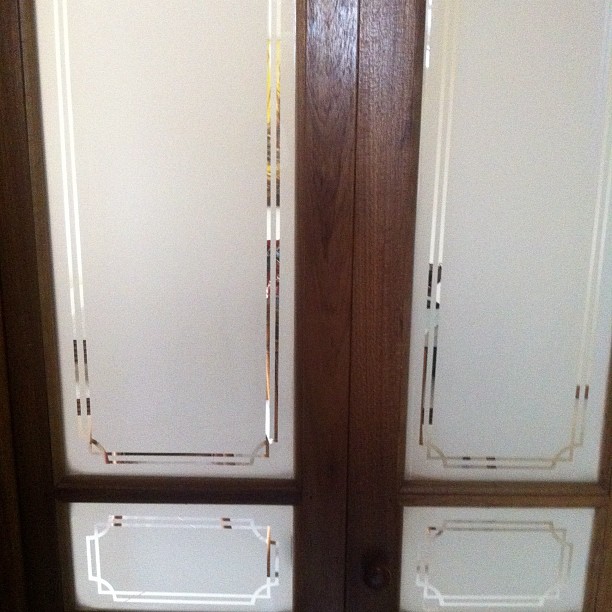 two double doors with no glass on them, and some brown trim