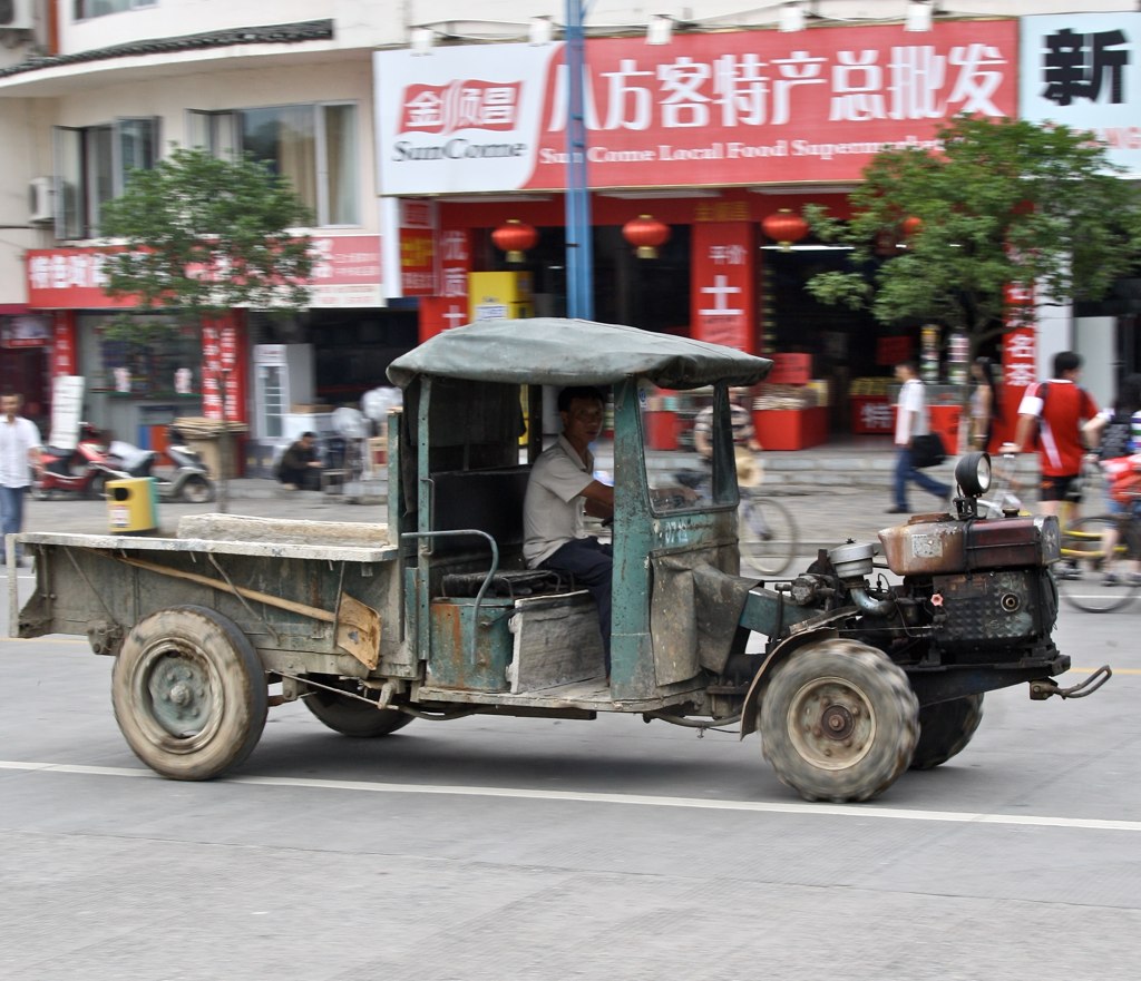 a very old truck driving down the road