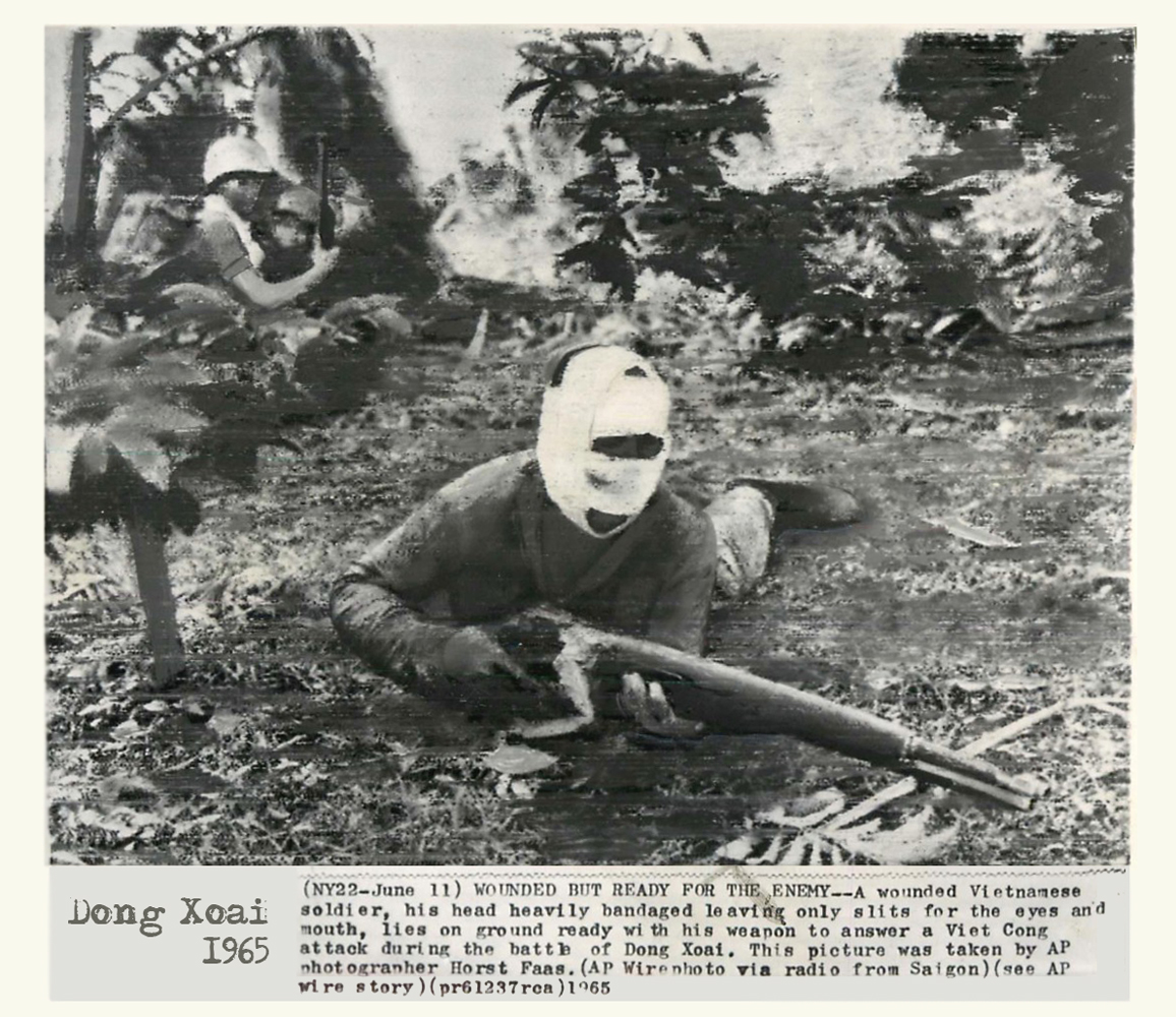 a man wearing a mask holds a rifle