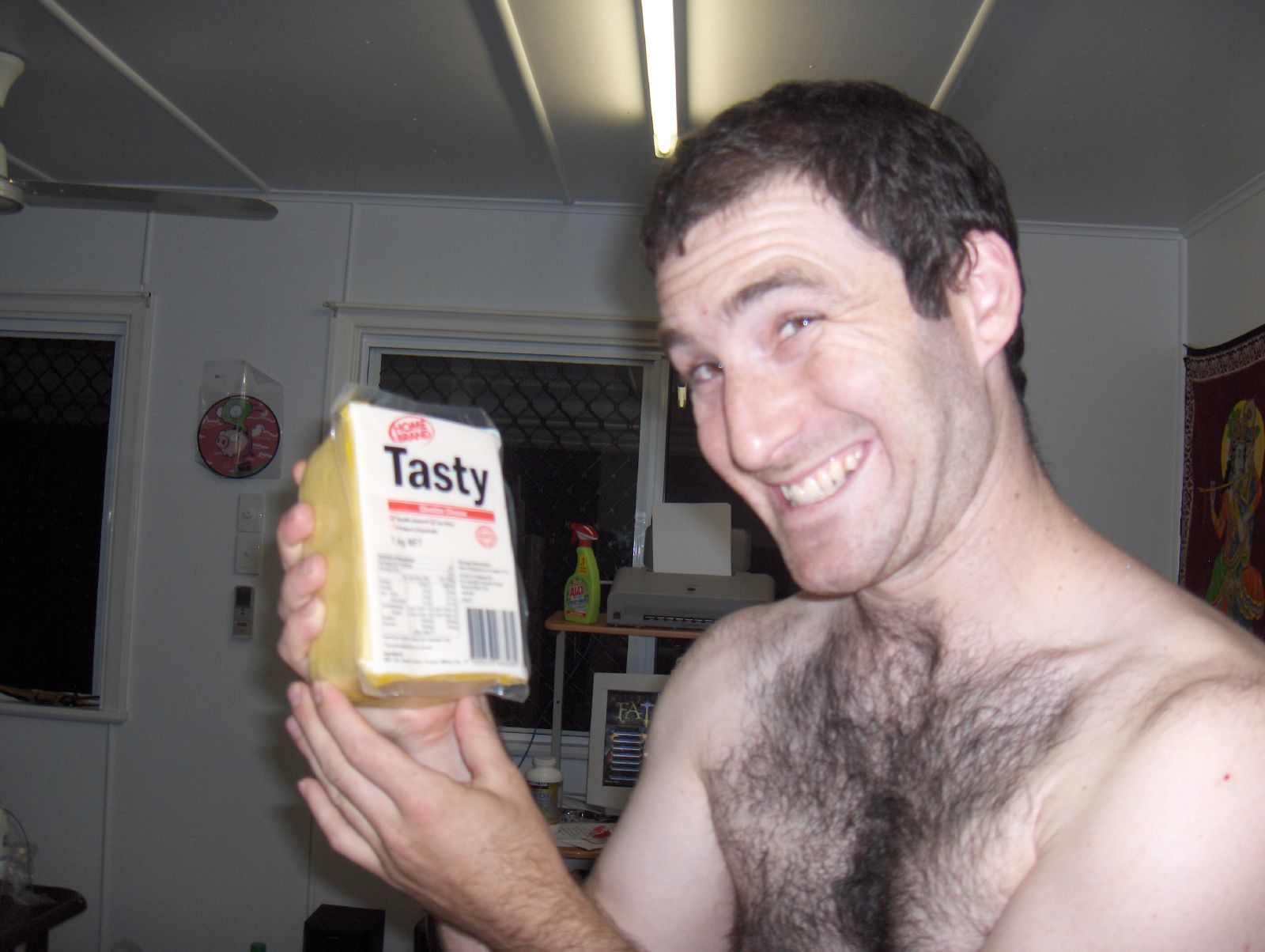 a man with a box of tasty cheese in his hand