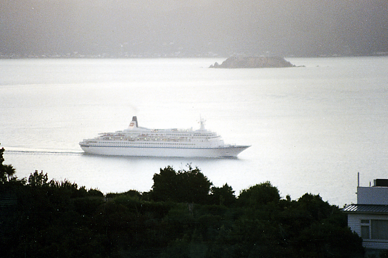 a large white cruise ship in the water