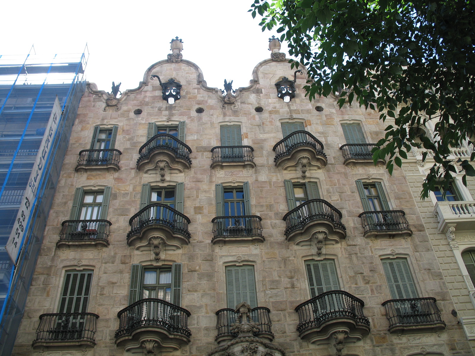 a tall building with balconies and many windows