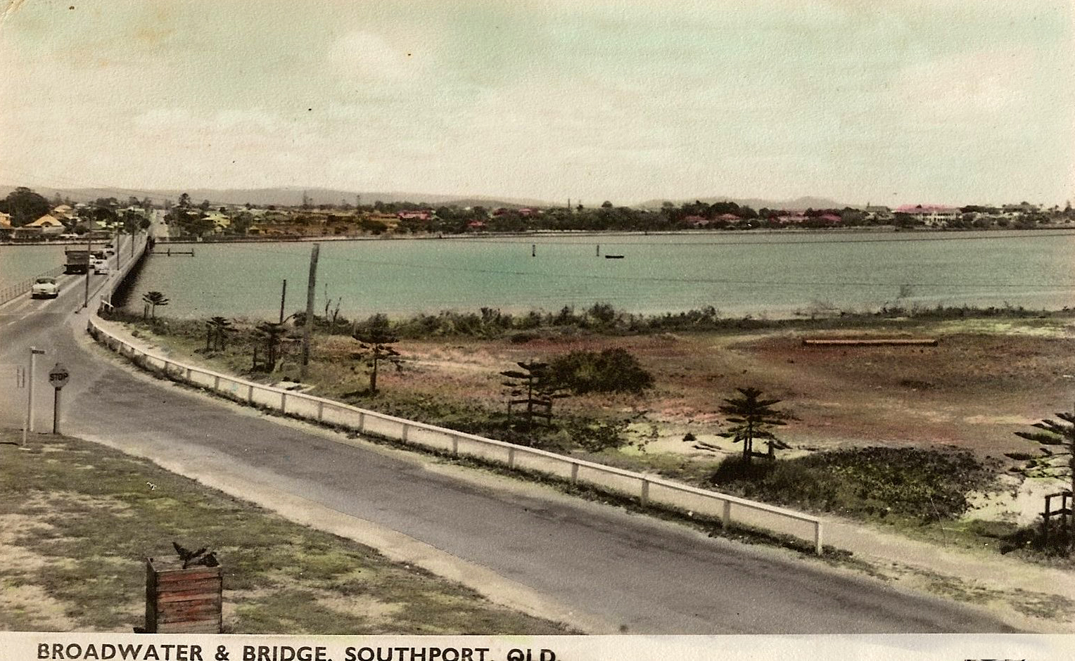a vintage pograph of a lake and road near beach
