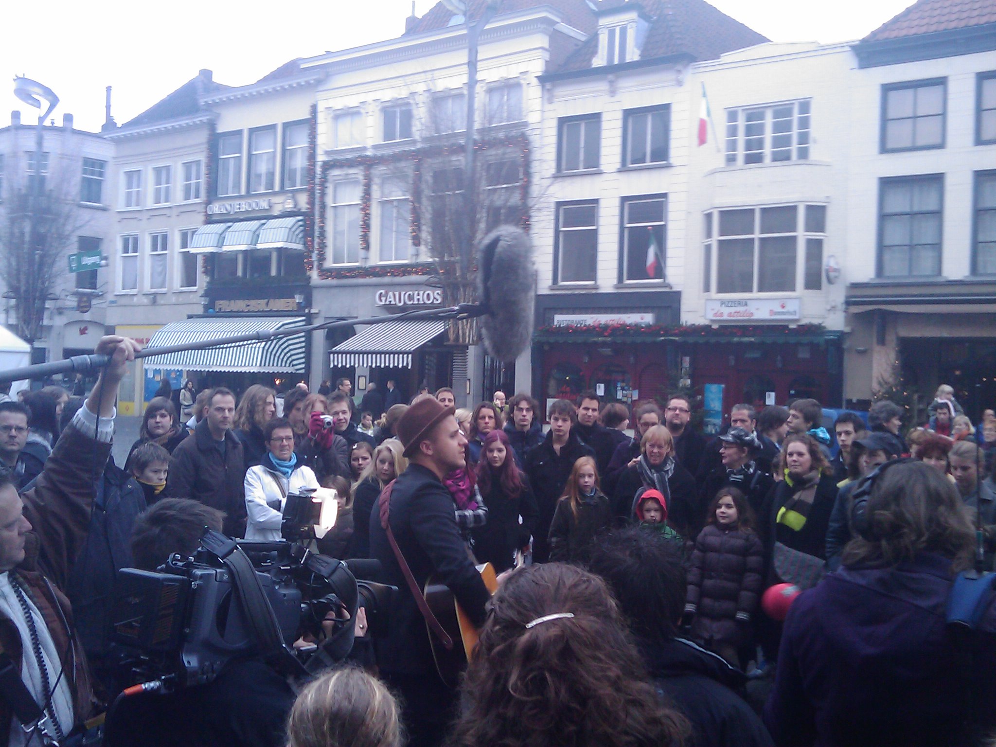 people gather in front of an old building