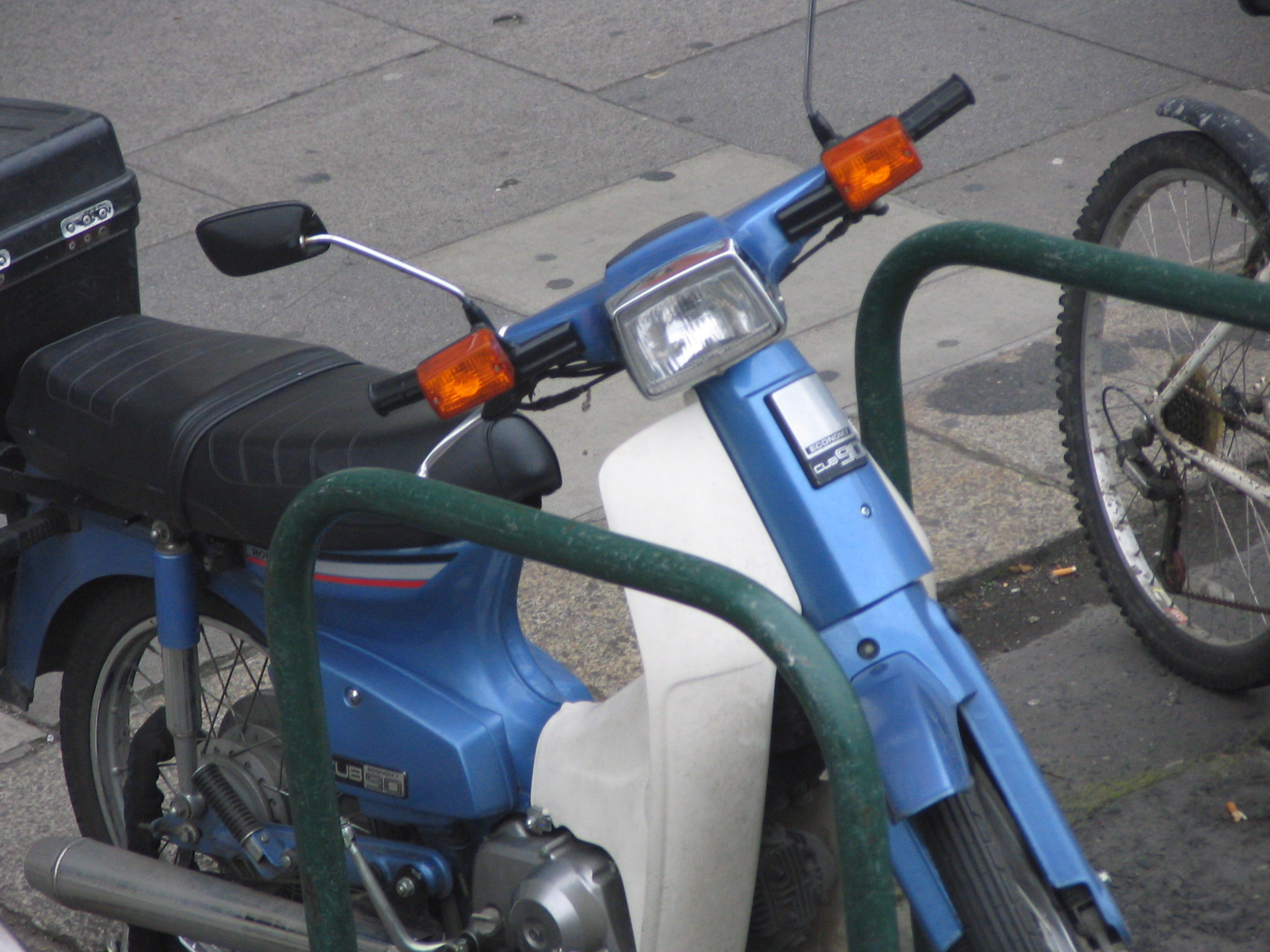 a motor scooter parked by a curb