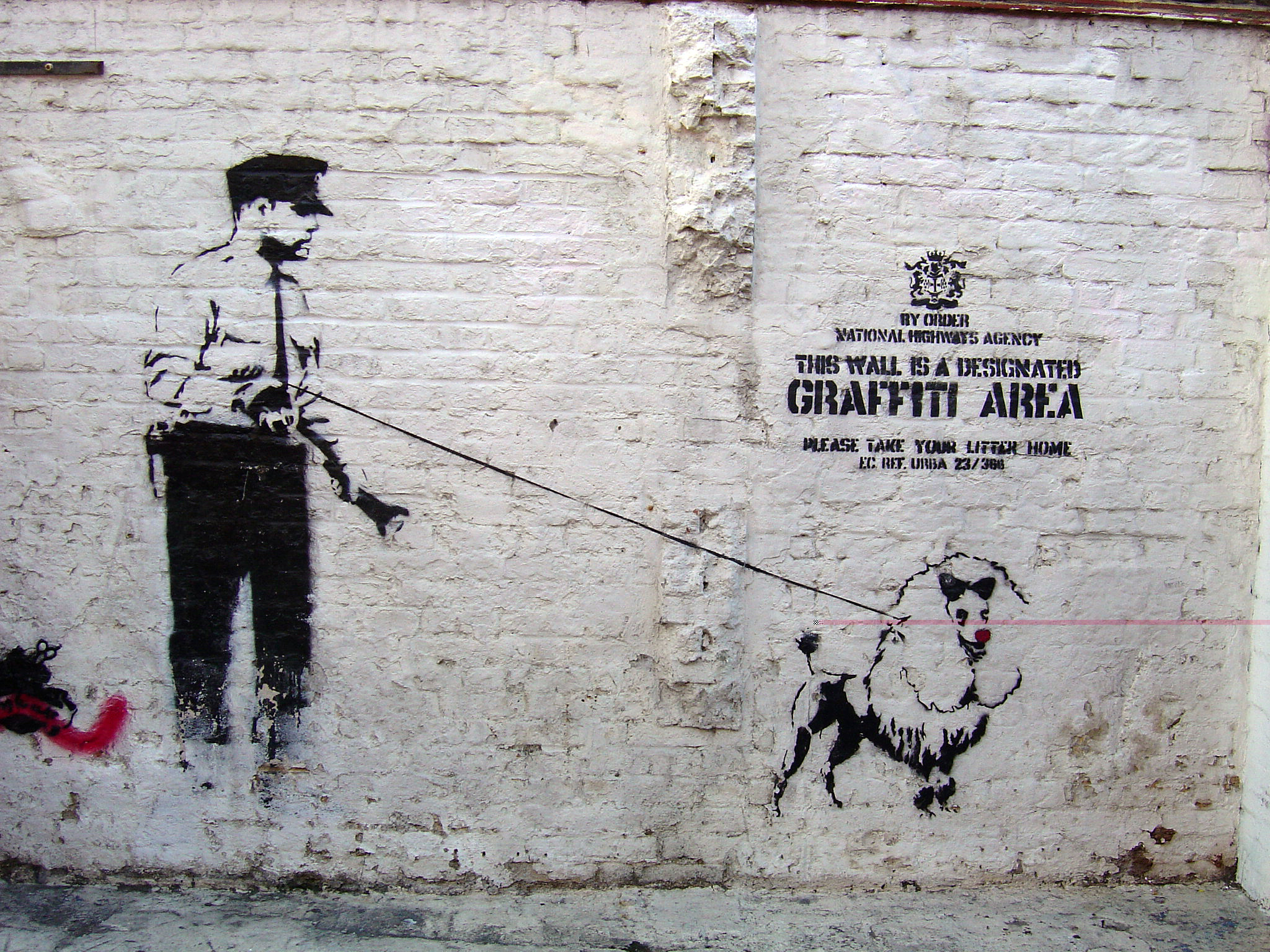 a painted wall with an ad of a man and dog with a cane