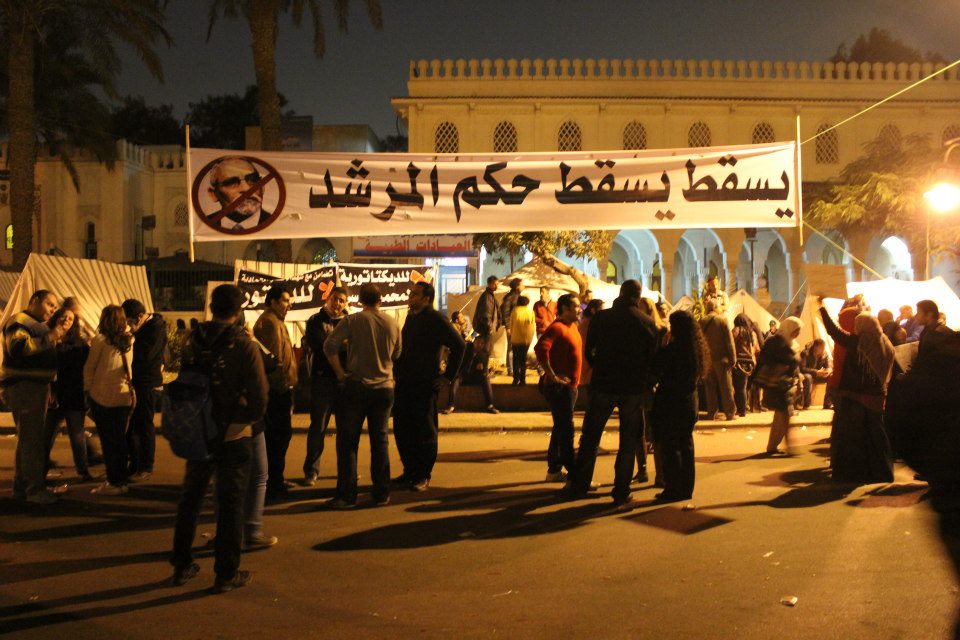 protesters standing around in front of a demonstration