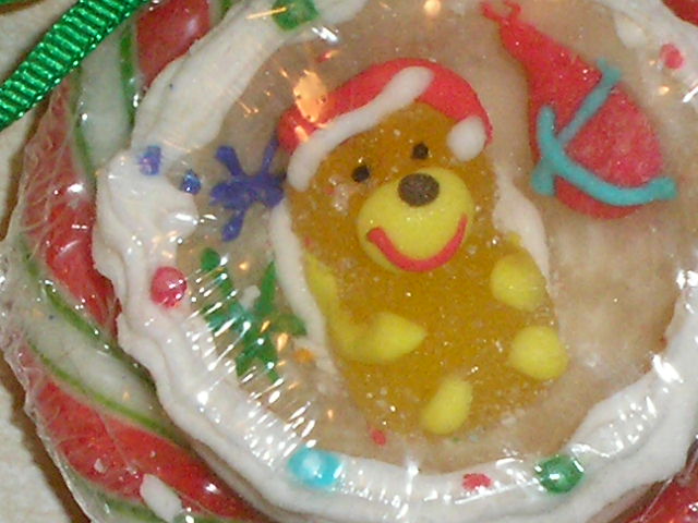 a very cute little toy teddy bear in a hat on a plate