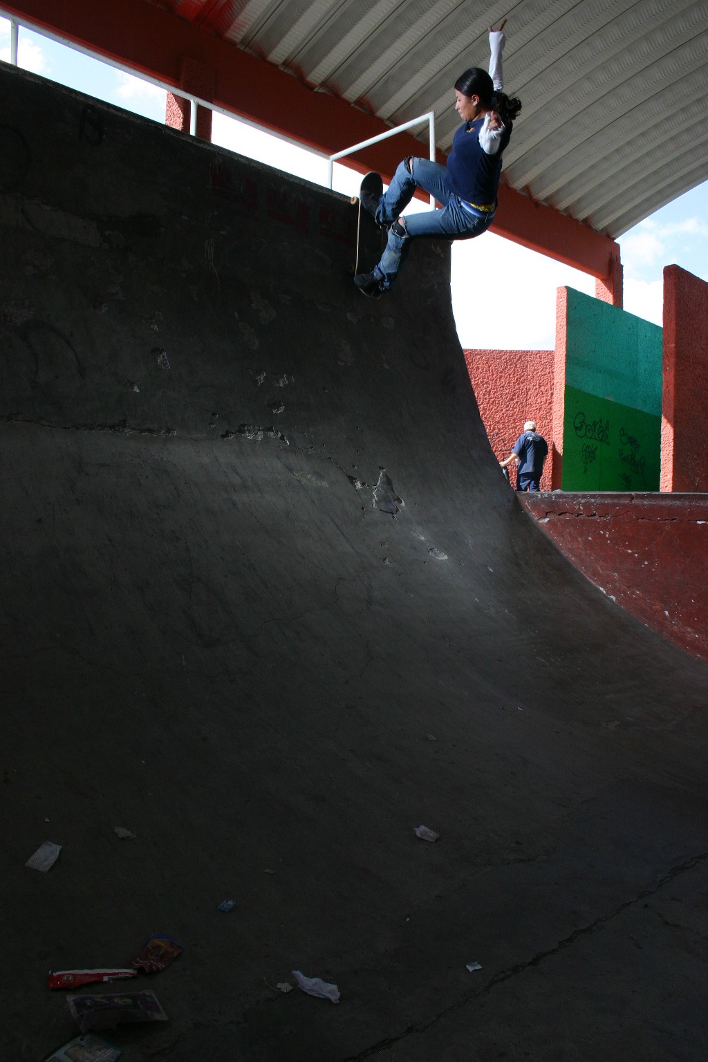 there is a man riding a skateboard down the side of a ramp