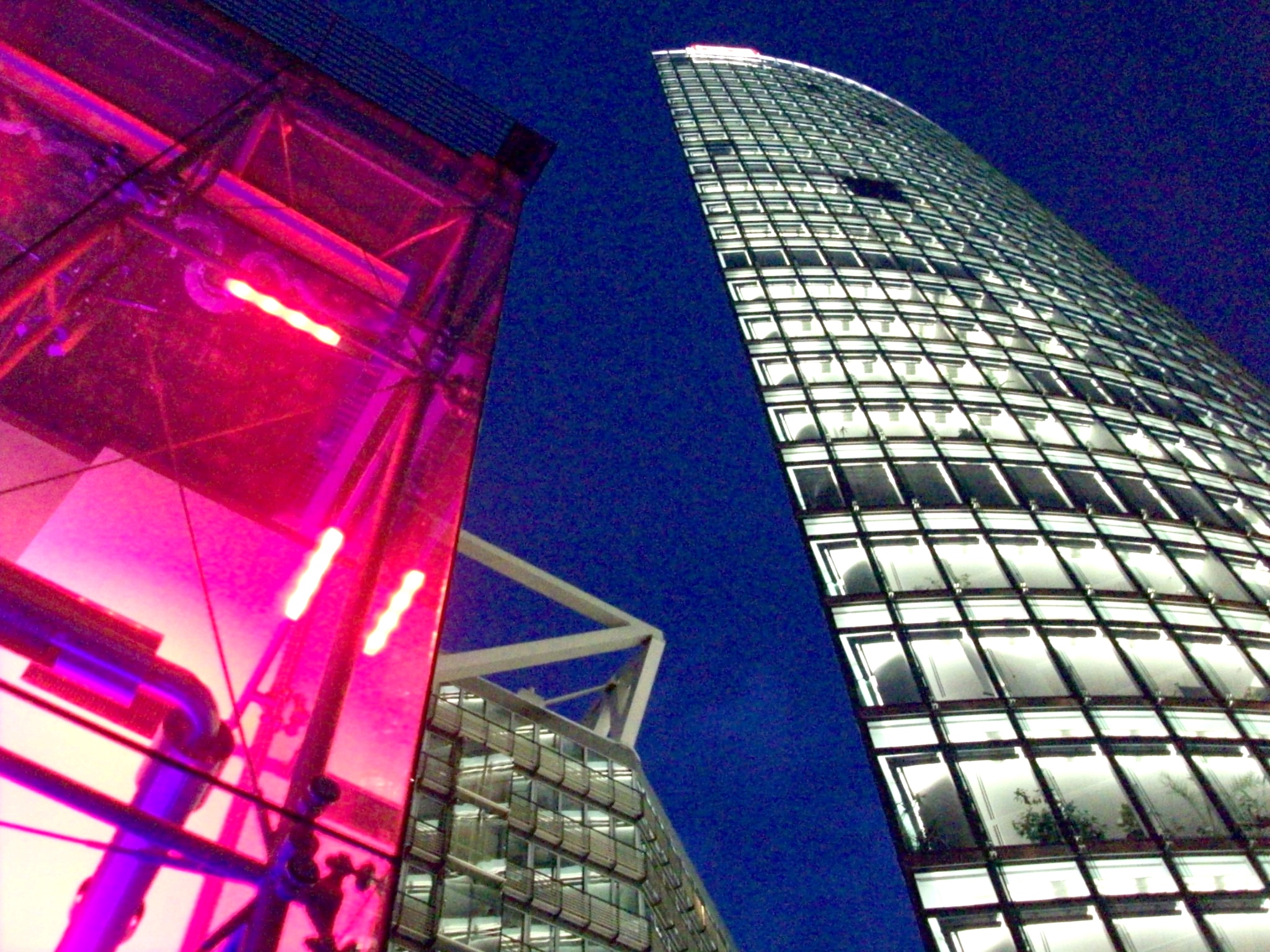 looking up at two skyscrs with lights