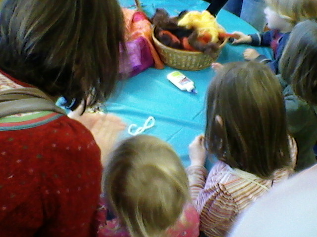 several children looking at a stuffed animal and toy duck