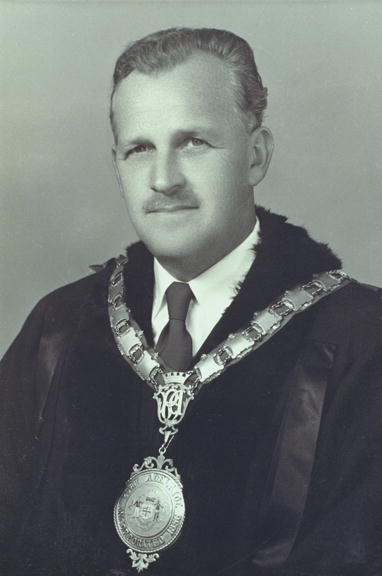 a man with an order medal and a suit