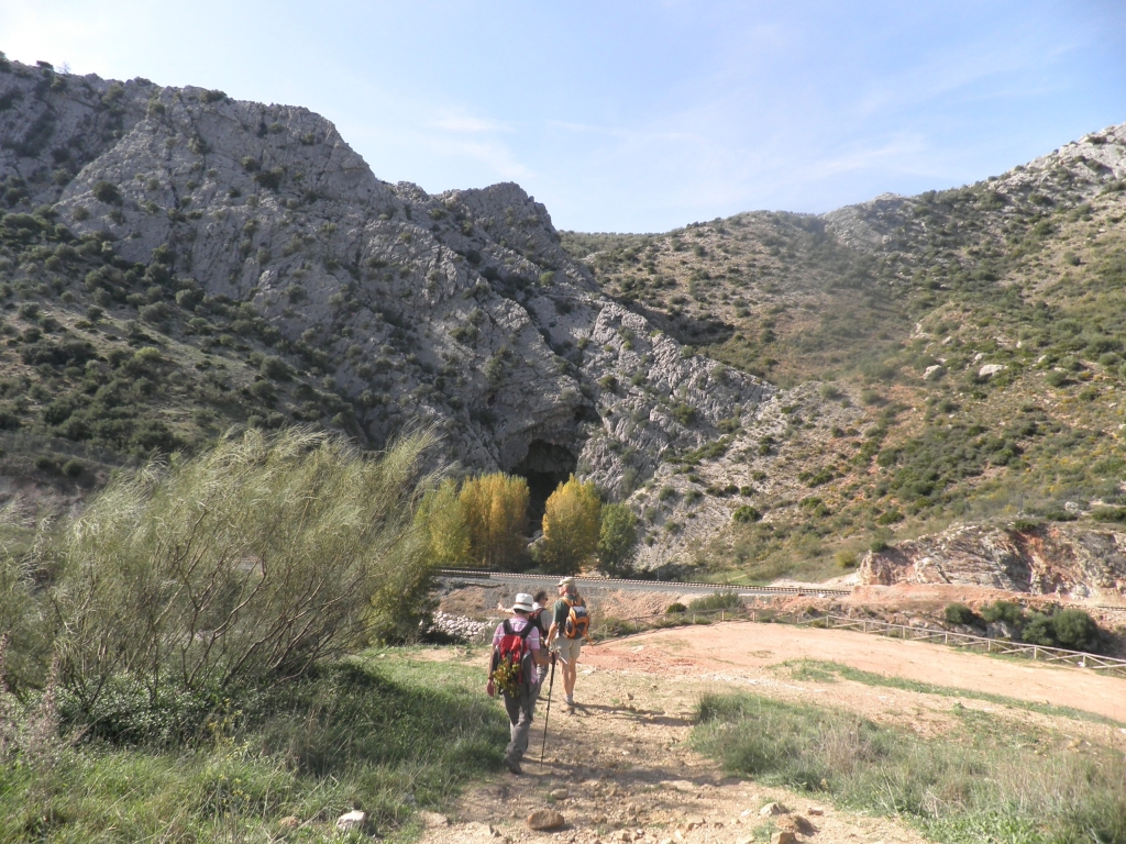 two people hiking through the mountains, some with backpacks