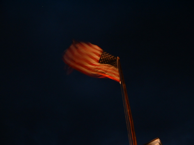 an american flag is flown high in the sky