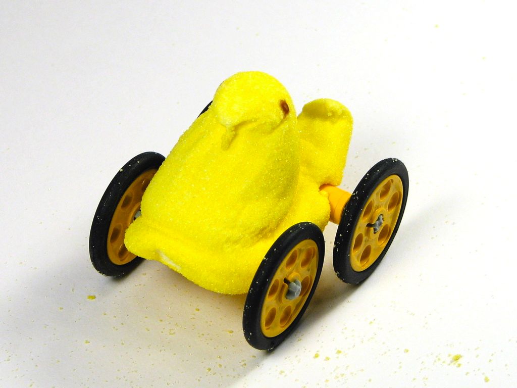 a toy car made out of yellow foam on a white table