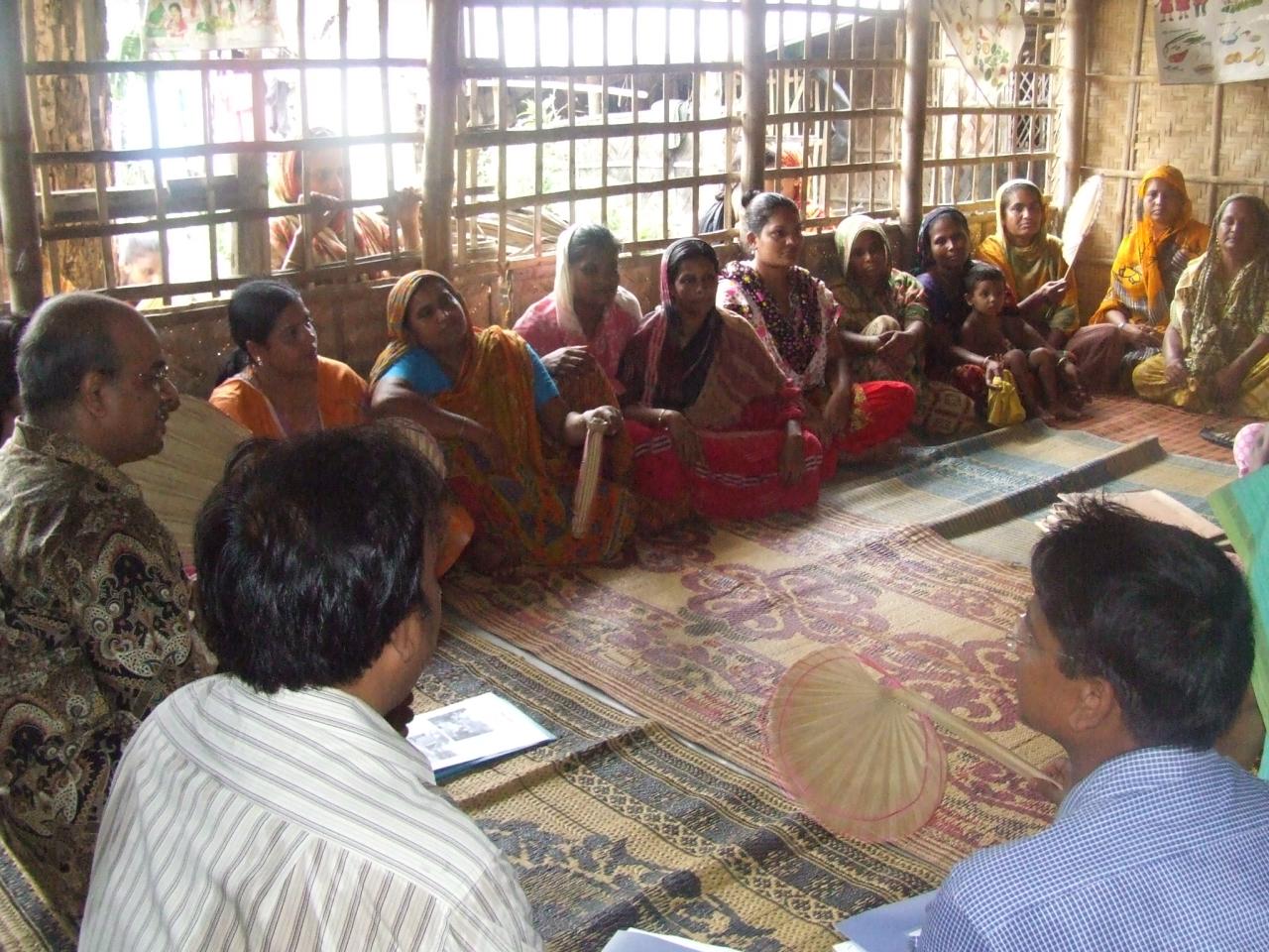 several people sitting around in a circle together