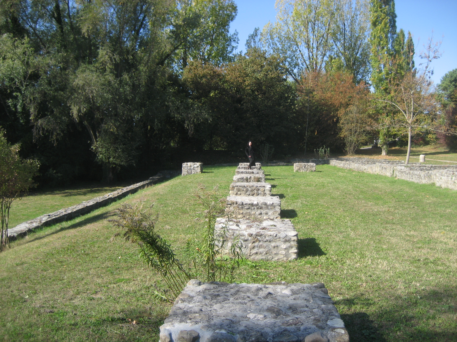 a long row of stone benches in a grassy area