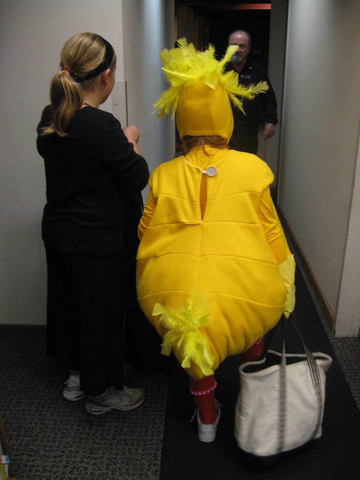 a woman in a costume is standing in the corridor