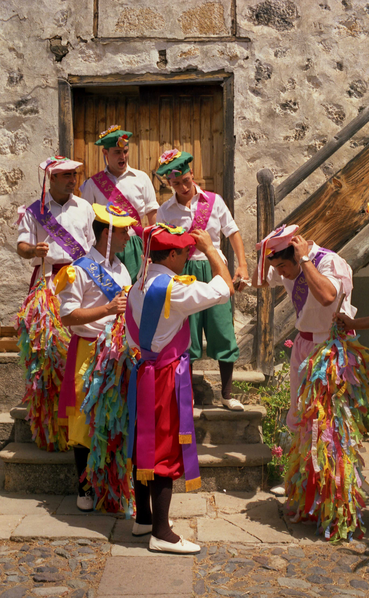 there are men and women dressed in colorful outfits