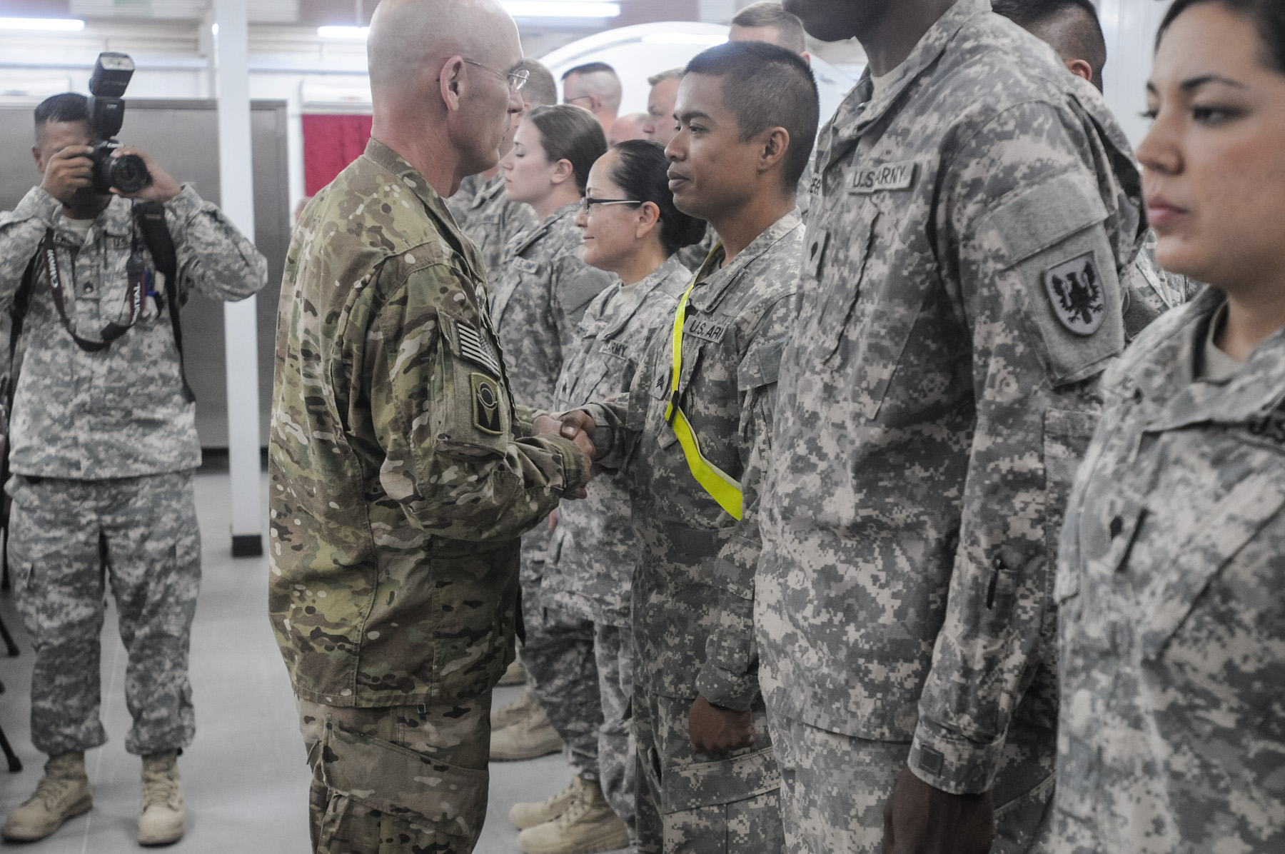 several people in army uniforms stand and take pictures