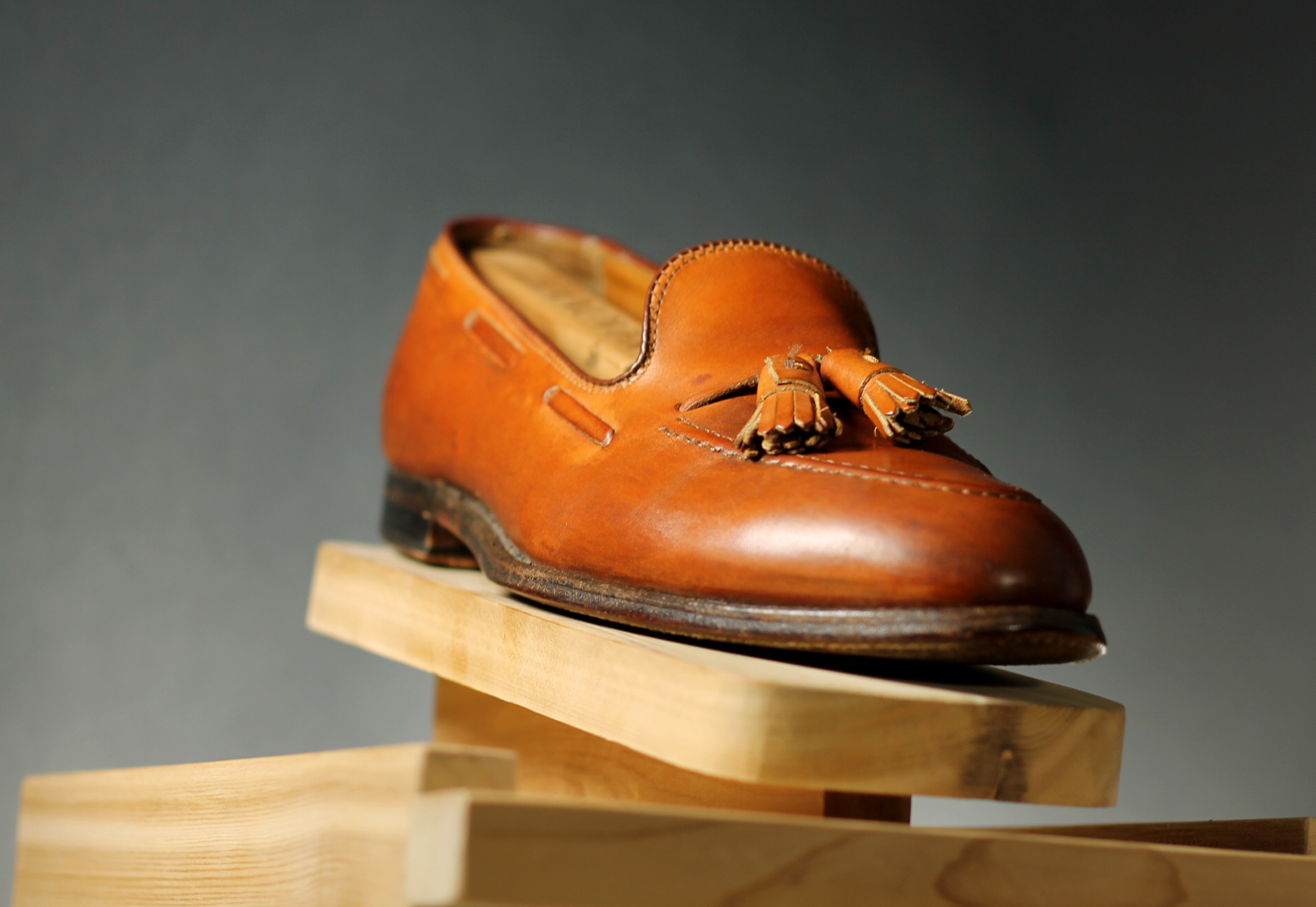 a brown pair of shoes on a wooden table