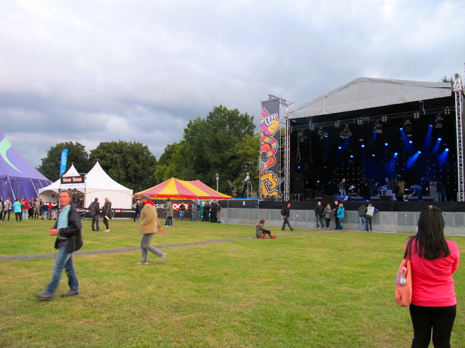 a stage set up on a lawn surrounded by several people