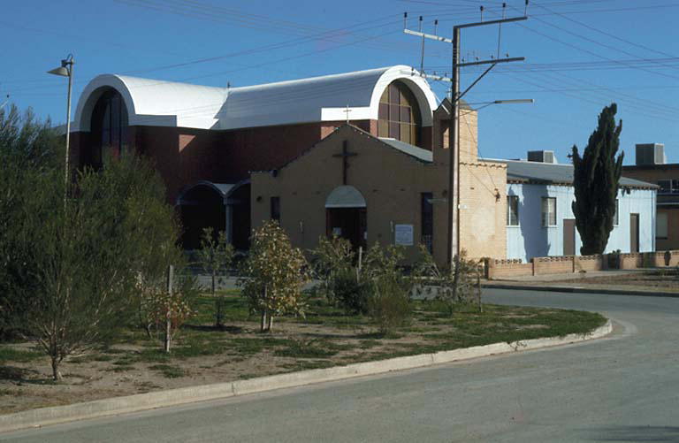 a church building sits on the side of the road