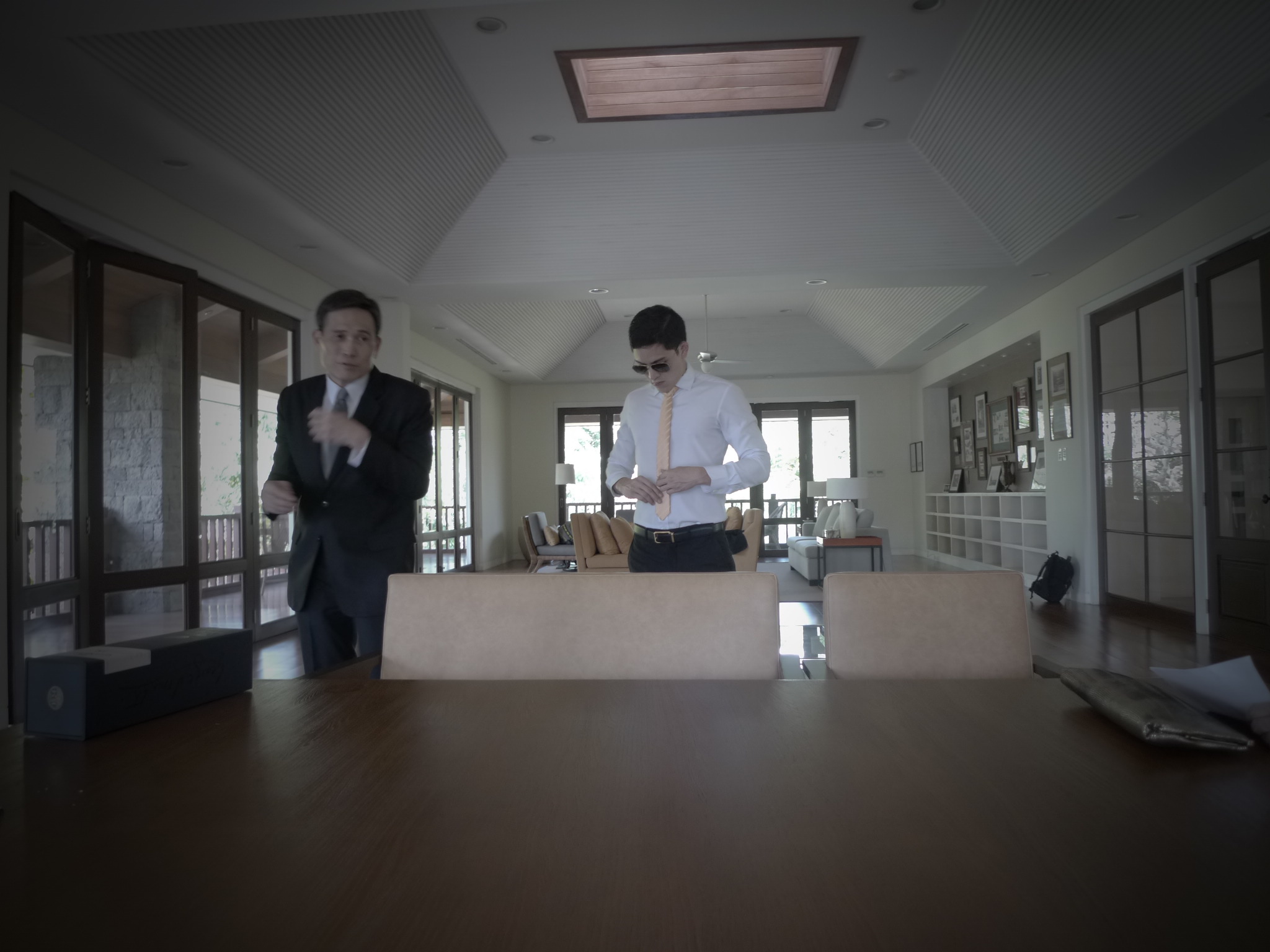 two young men in formal attire standing in a room