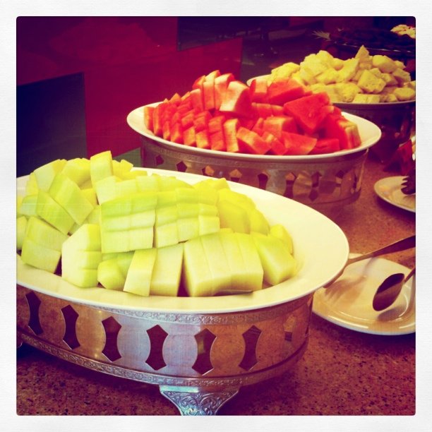 a large assortment of cut fruit is on display