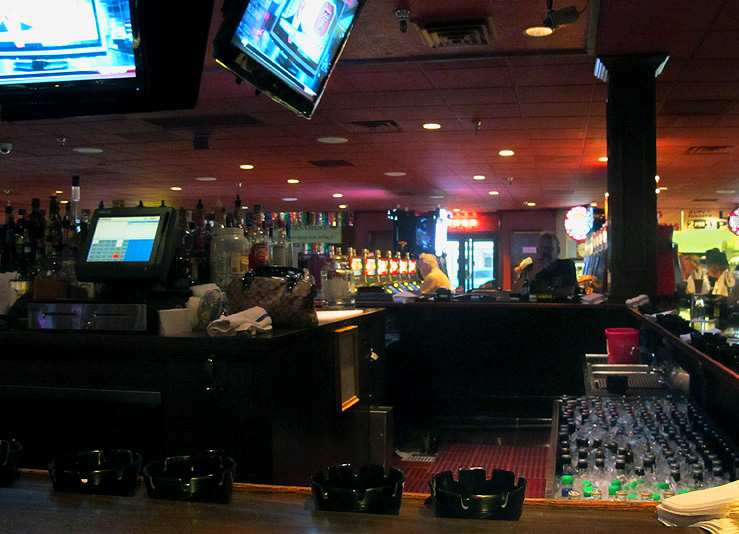 televisions at a bar with neon lights