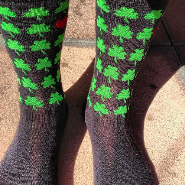 a person has green socks with shamrocks on them