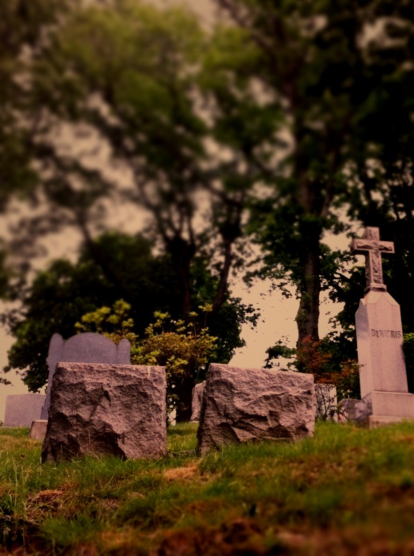 a stone memorial sitting in a cemetery