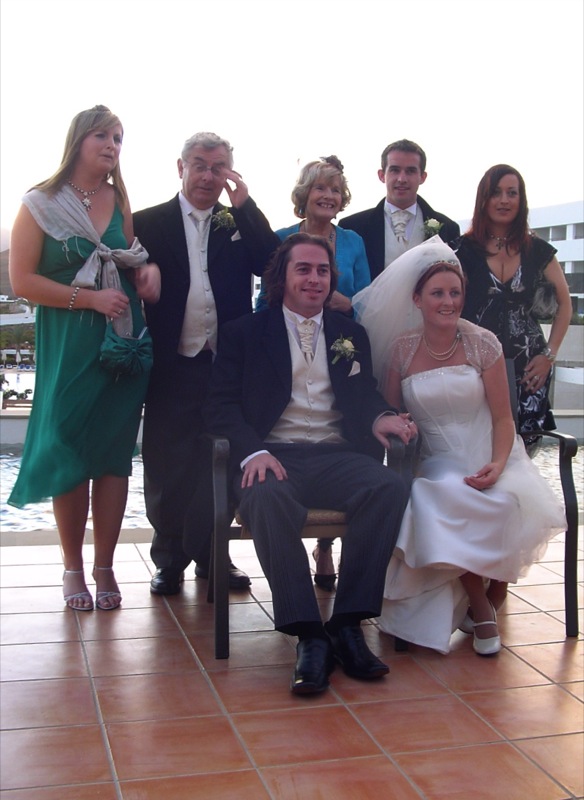 a group of people wearing formal attire poses together