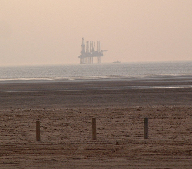 the oil rig is on the horizon of the ocean