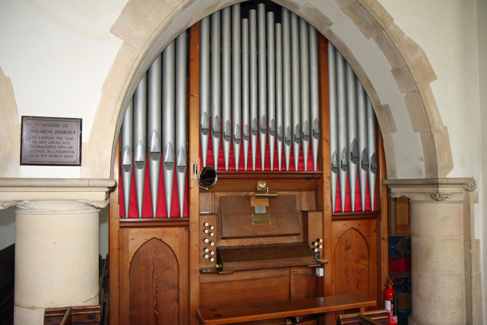 a church organ with wooden paneling and pipe organ