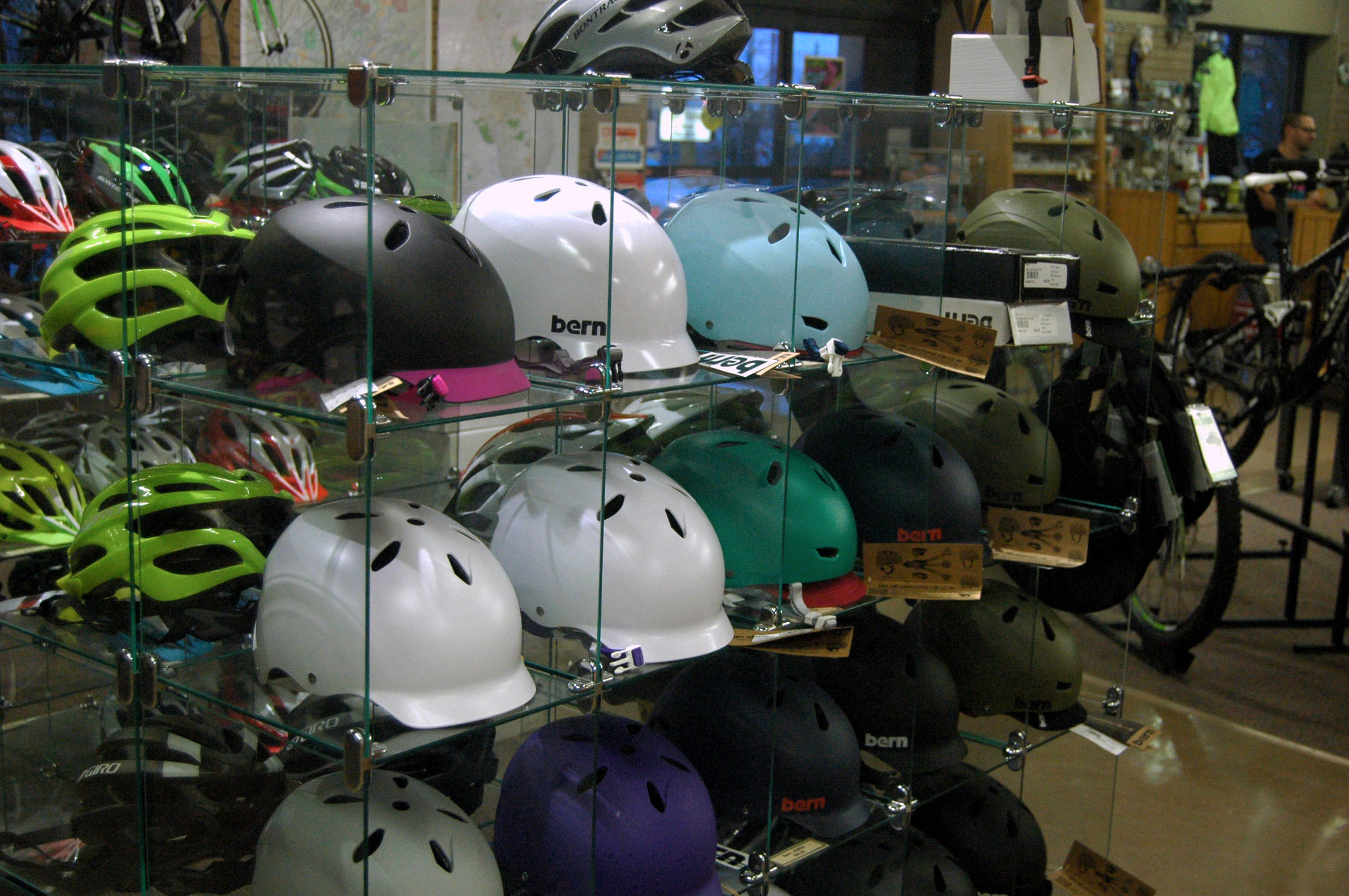 helmets hanging in a display in a shop