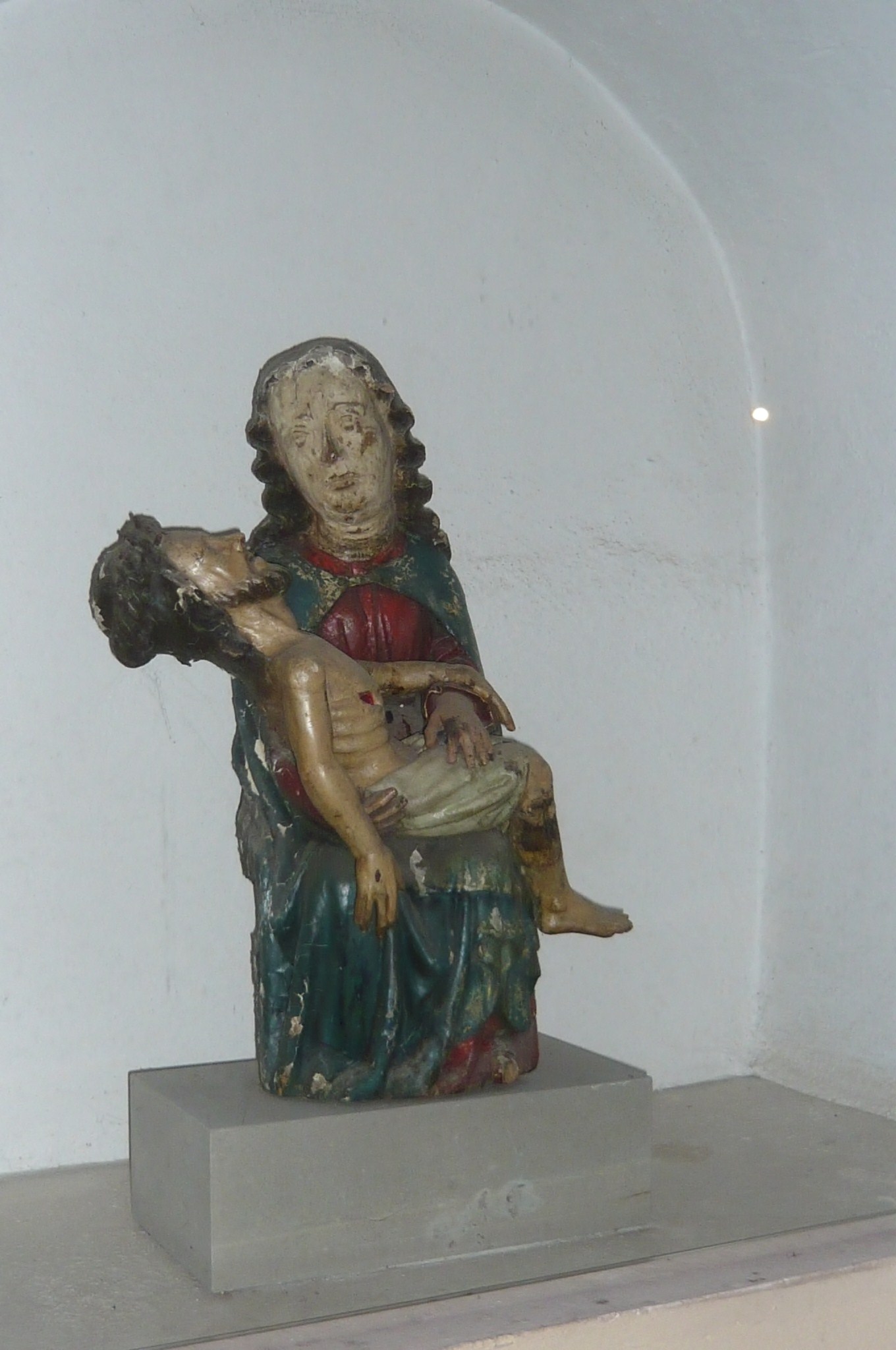 a statue holding a baby and looking down
